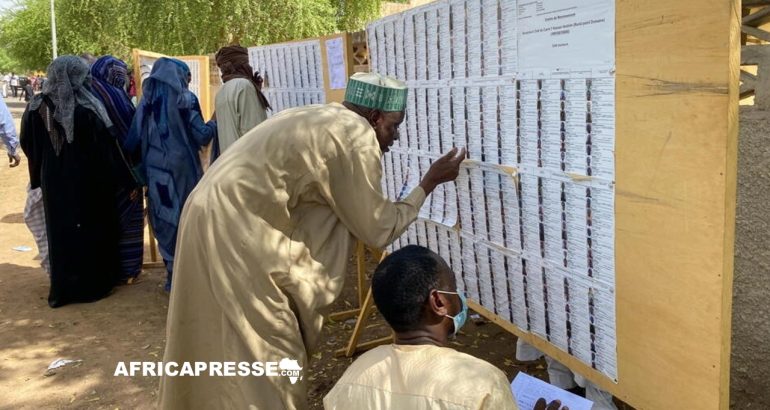 Des électeurs tchadiens cherchant leurs noms dans les registres d'un centre de vote pour la présidentielle à Ndjamena